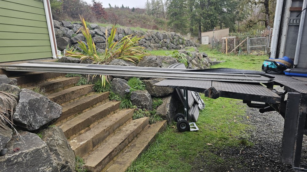 Custom ramp bridging a truck lift gate to stone steps