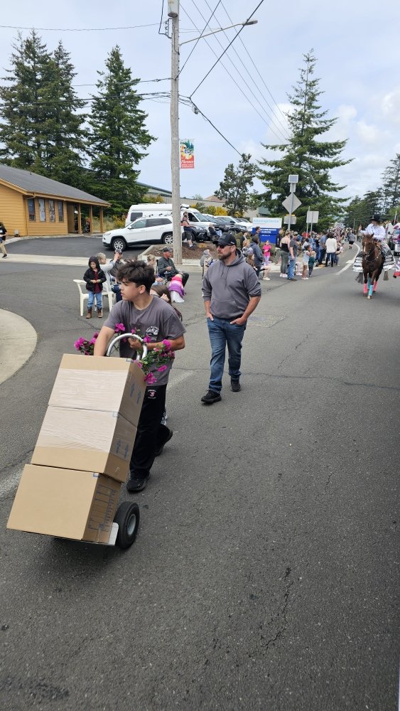 Hand truck of boxes down the parade route