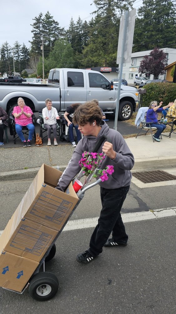 Boxes rolling past parade spectators