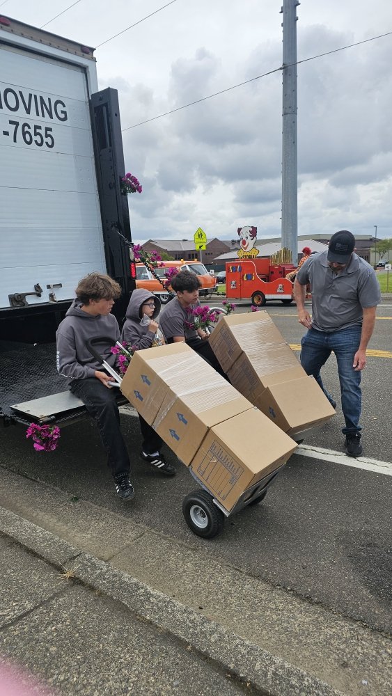 Crew unloading boxes from the truck during the parade